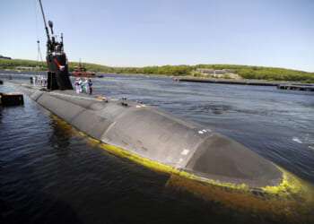 Sailors aboard the Los Angeles-class fast-attack submarine USS Hartford wait during repairs