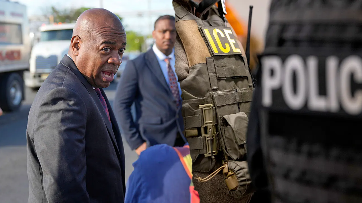 Ras Baraka, left; ICE officer right