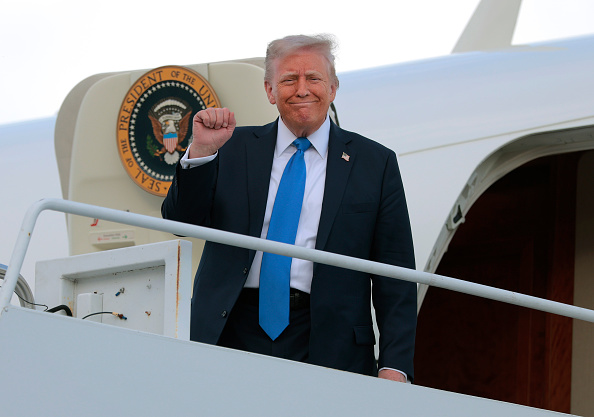 President Donald Trump disembarks from Air Force One at Tuscaloosa National Airport