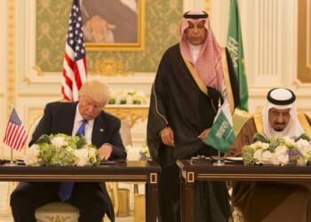 Two men sitting next to each other.