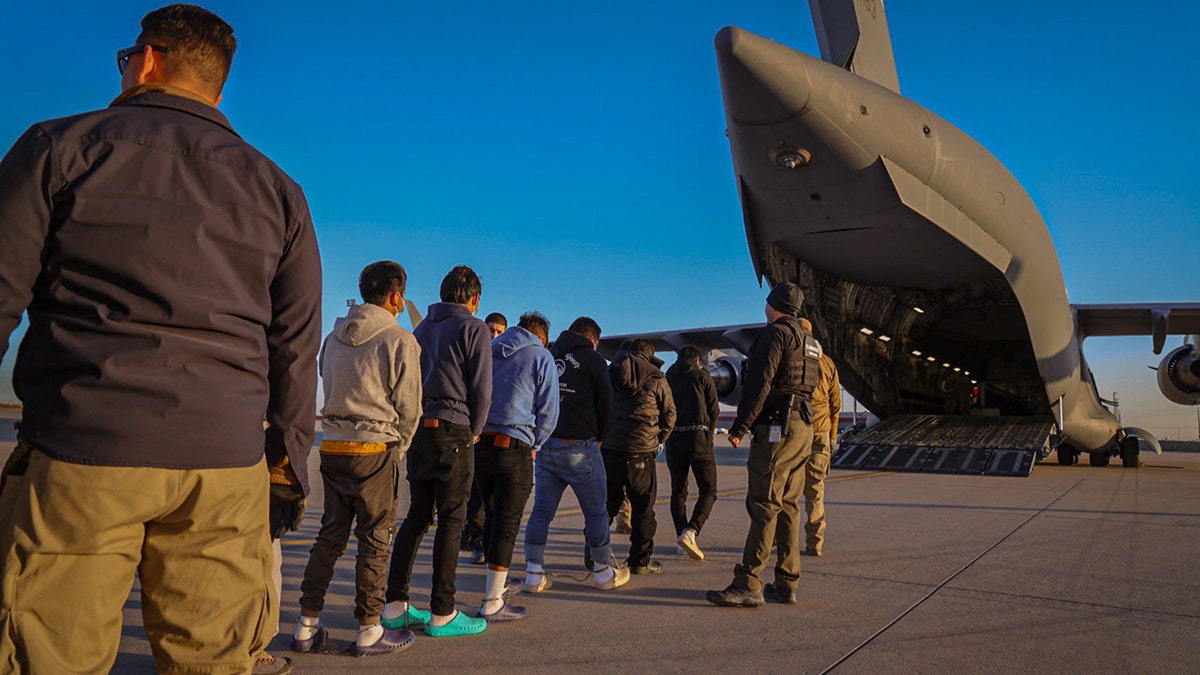 me lined up to get on deportation plane