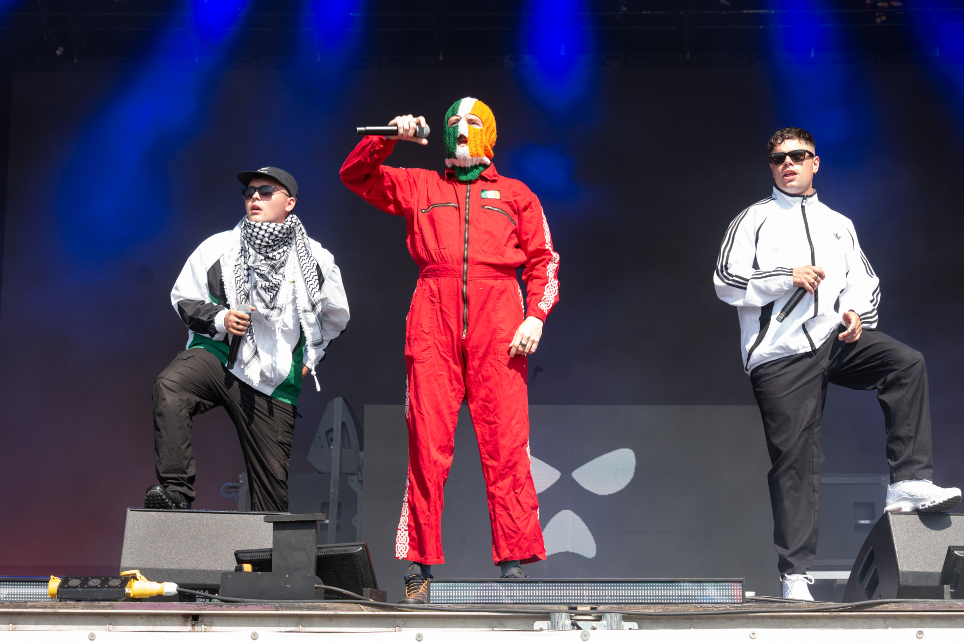 GLASTONBURY, ENGLAND - JUNE 28: Mo Chara, DJ Provaí and Móglaí Bap of Kneecap perform on the West Holts stage during day four of Glastonbury festival 2025 at Worthy Farm, Pilton on June 28, 2025 in Glastonbury, England. Established by Michael Eavis in 1970, Glastonbury has grown into the UK's largest music festival, drawing over 200,000 fans to enjoy performances across more than 100 stages. In 2026, the festival will take a fallow year, a planned pause to allow the Worthy Farm site time to rest and recover. (Photo by Ki Price/WireImage)