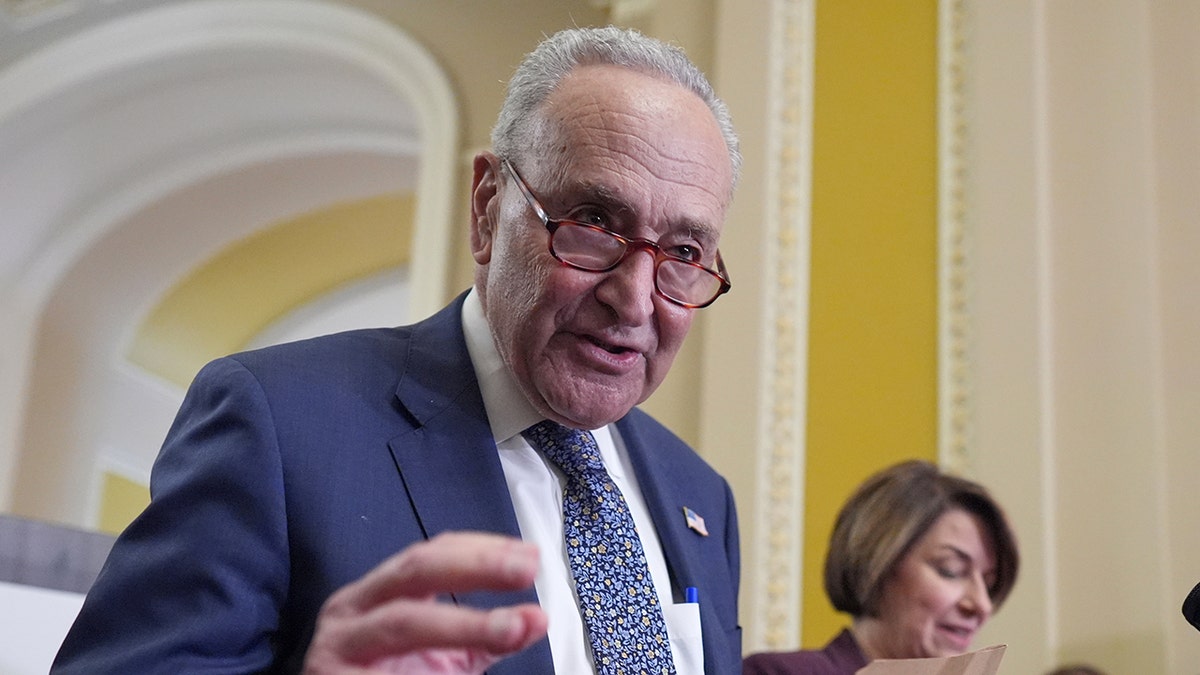 Senate Minority Leader Chuck Schumer, D-N.Y., joined by Sen. Amy Klobuchar, D-Minn., right, speak to reporters following closed-door party meetings at the Capitol in Washington, Tuesday, June 17, 2025.