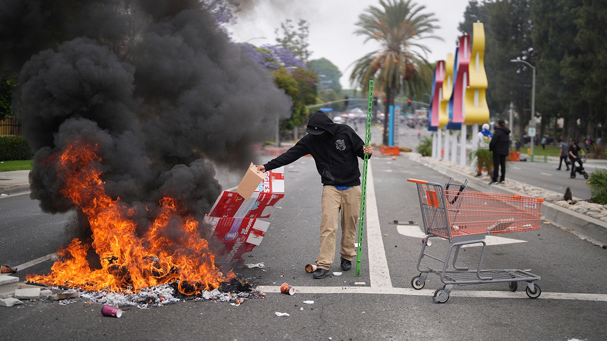 fire in street in anti-ICE protest in LA