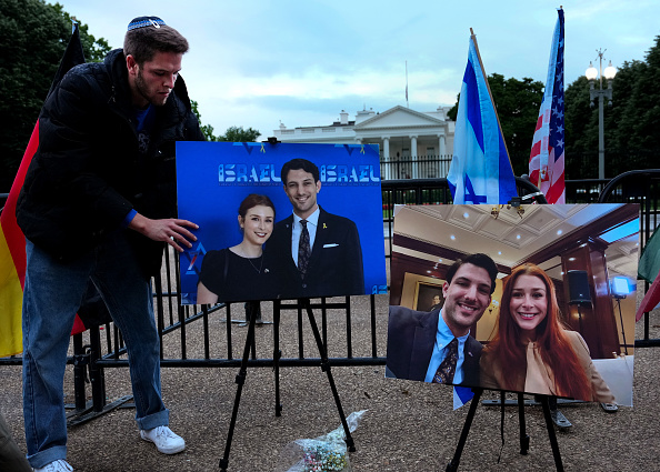Mourners gather for a vigil outside of the White House