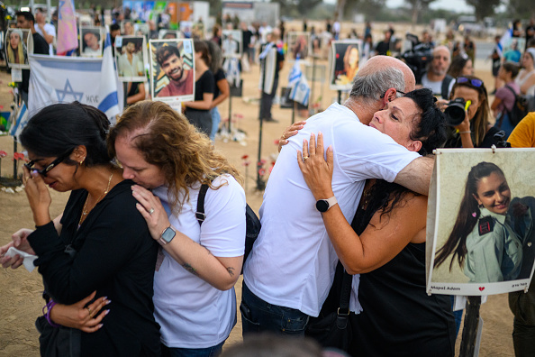 Family and friends gather at the Nova festival memorial