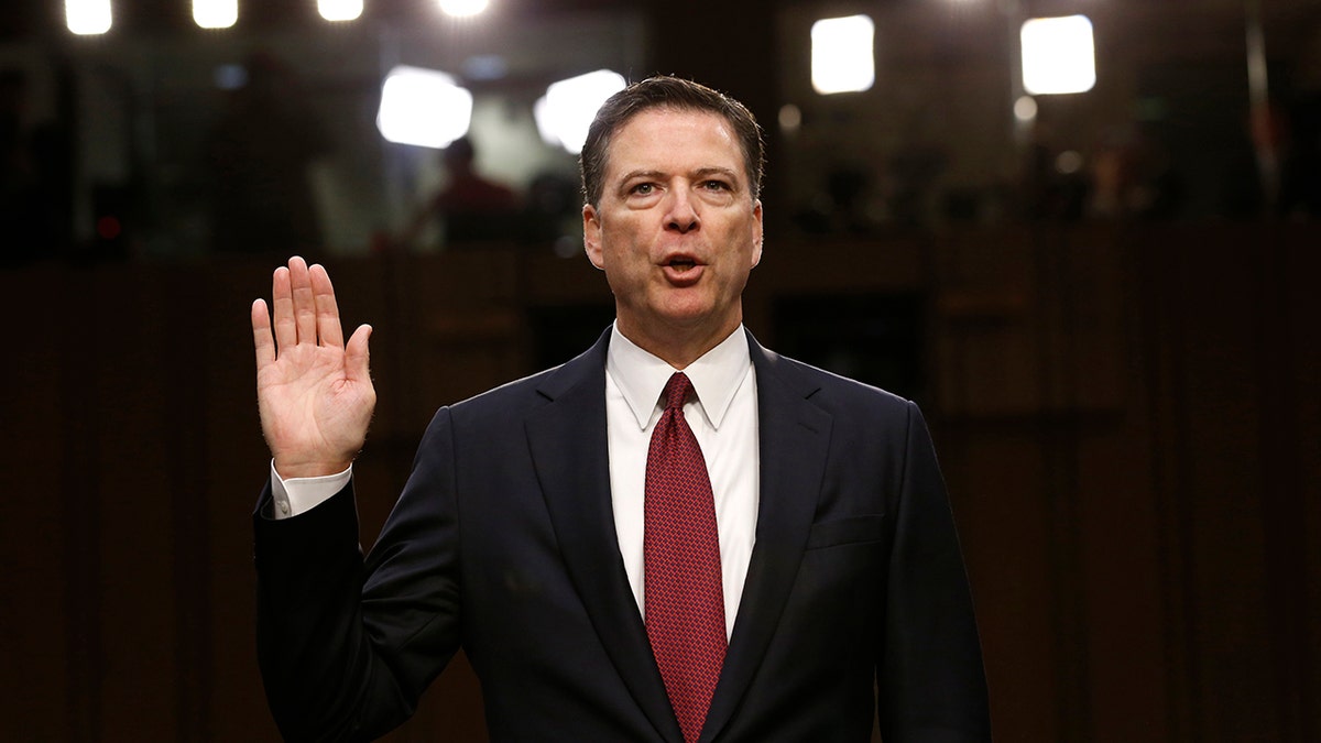 Former FBI Director James Comey is sworn in prior to testifying before a Senate Intelligence Committee hearing on Russia's alleged interference in the 2016 U.S. presidential election on Capitol Hill in Washington, U.S., June 8, 2017. REUTERS/Jonathan Ernst - HP1ED681C66SA
