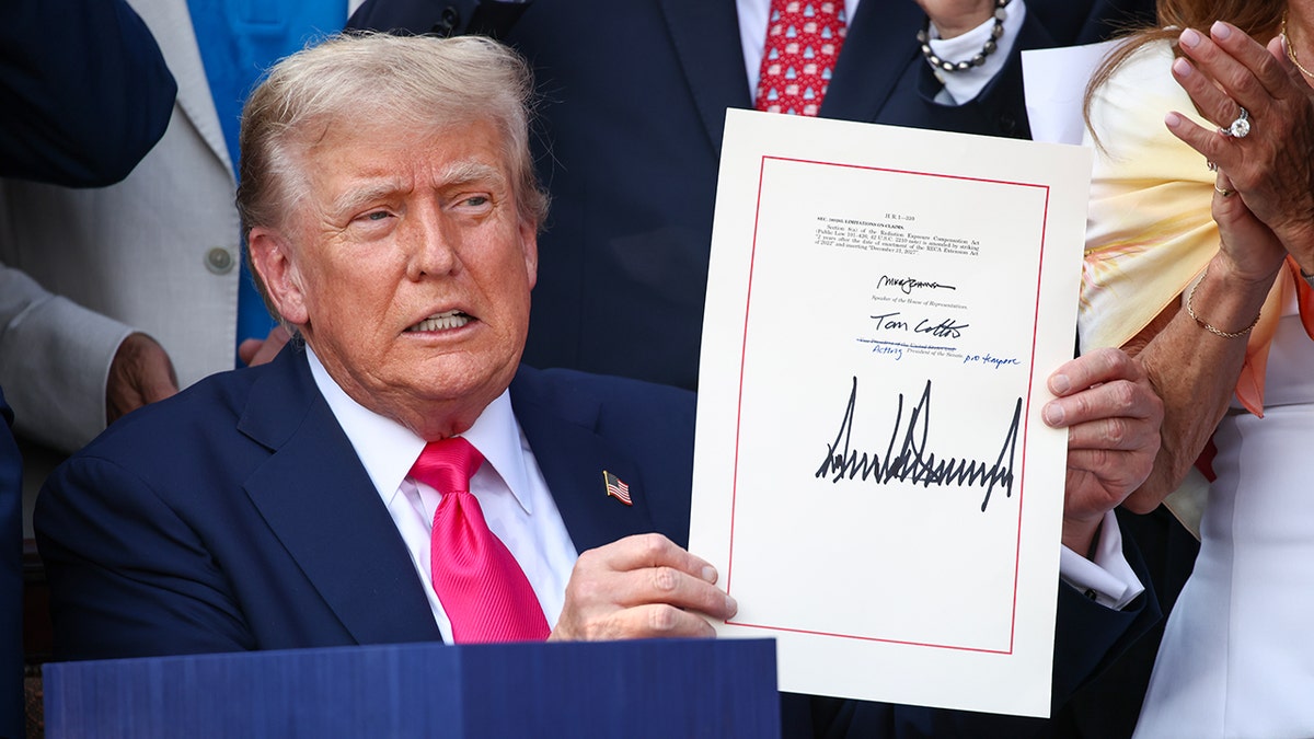 President Trump holding up signed 'big, beautiful bill'