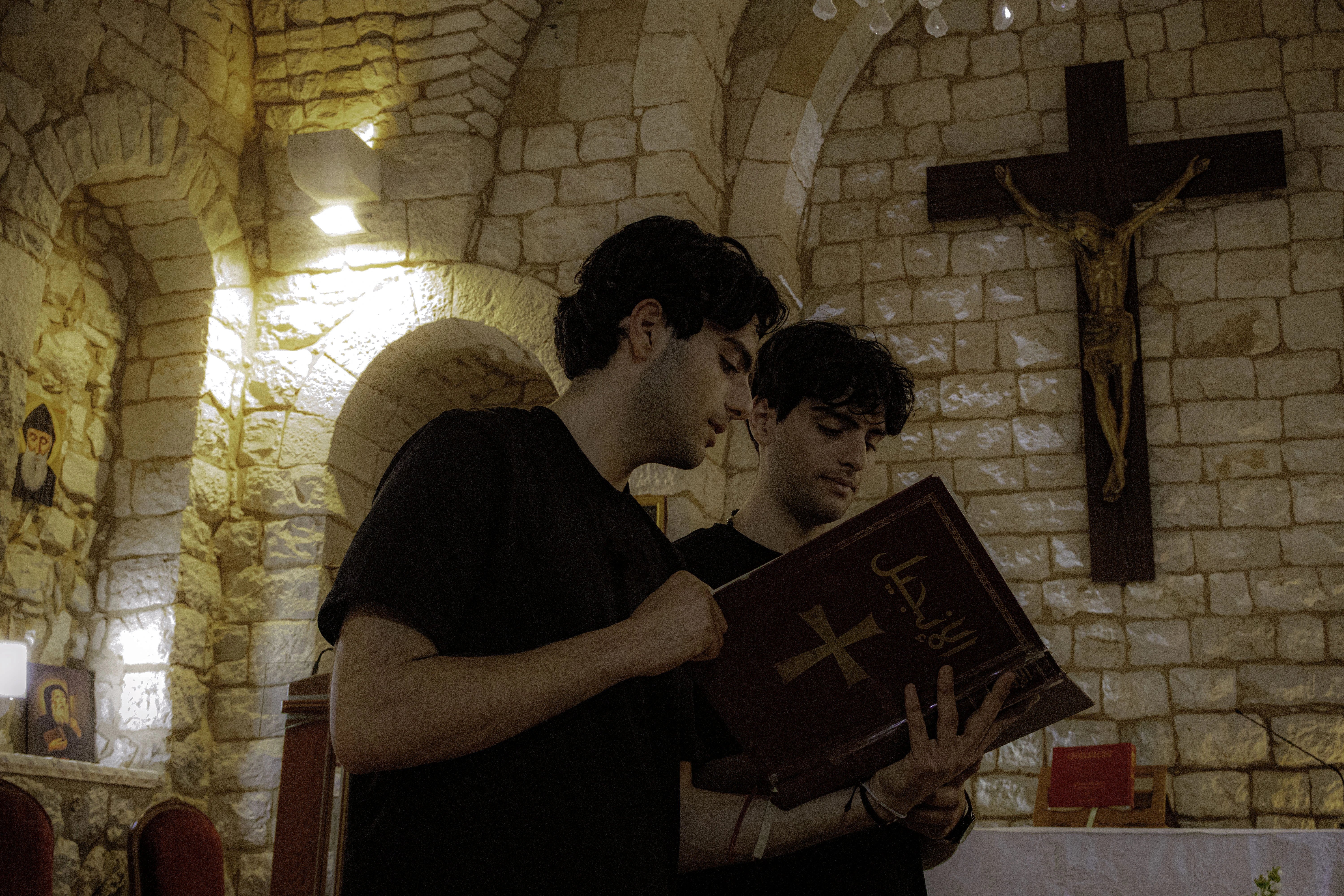 Charbel and Giovanni Lteif read the Bible in a church where they were filming content for their Instagram page. Credit: Photo courtesy of Charbel and Giovanni Lteif