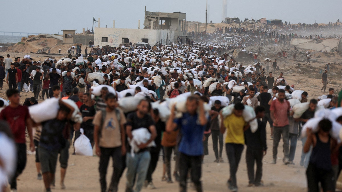 Palestinians carry aid supplies in Gaza