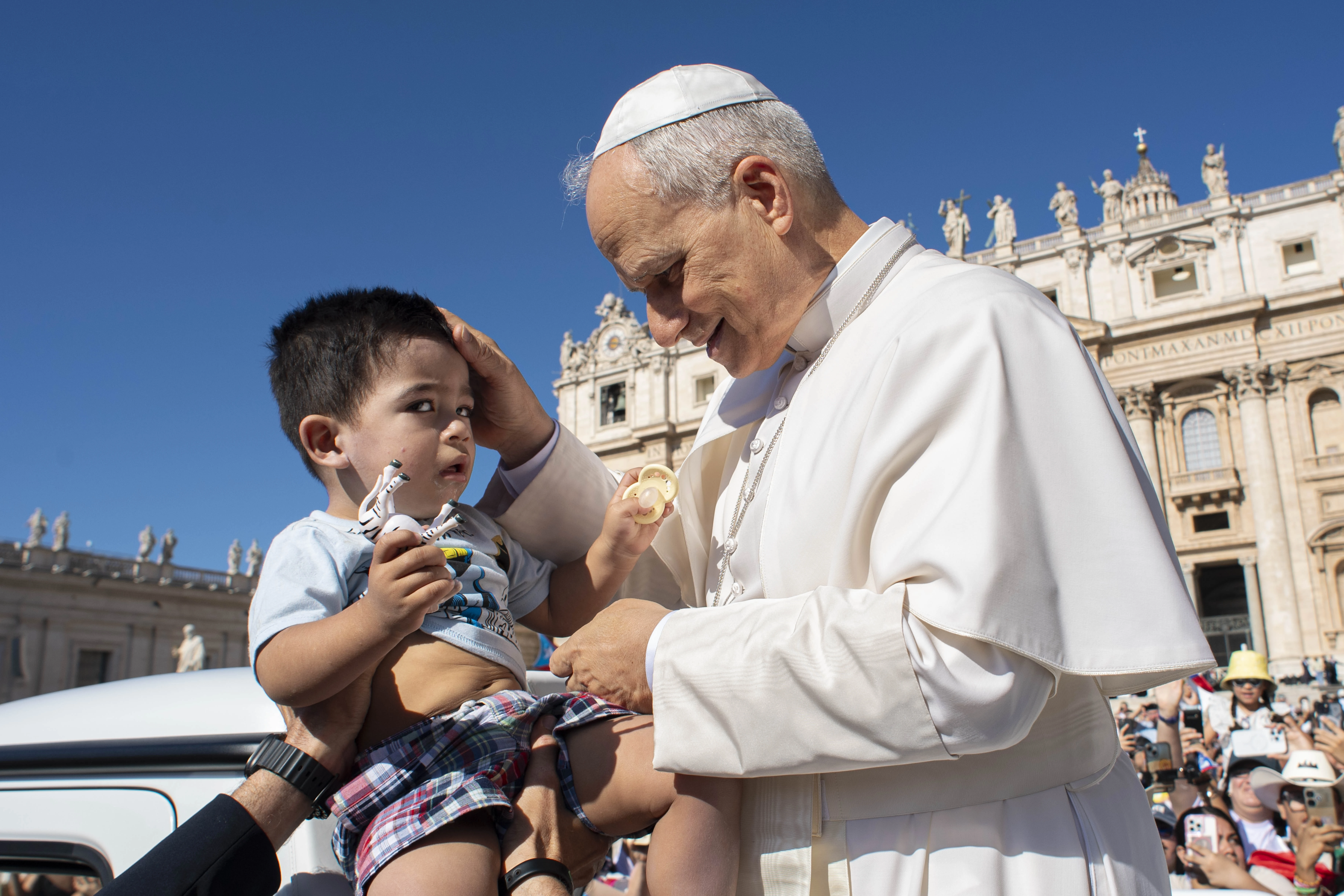 Pope Leo XIV blesses a toddler during his general audience on July 30, 2025, in St. Peter’s Square at the Vatican. Credit: Vatican Media