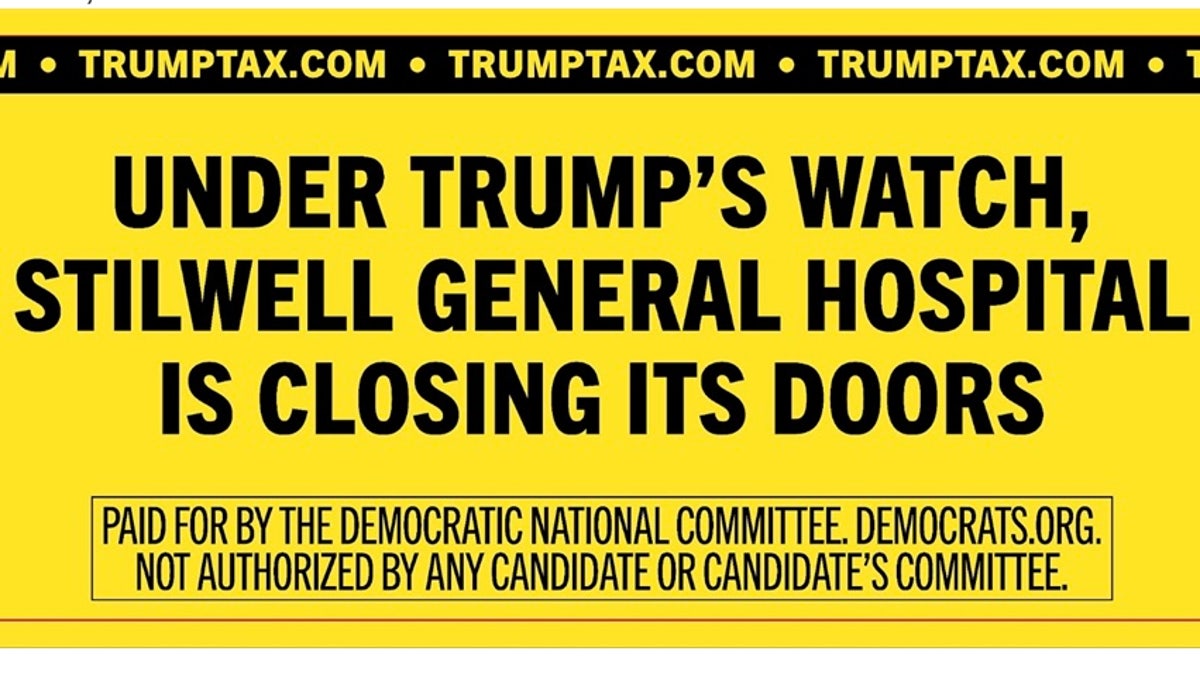 anti-Trump billboard sign featuring black text on yellow background