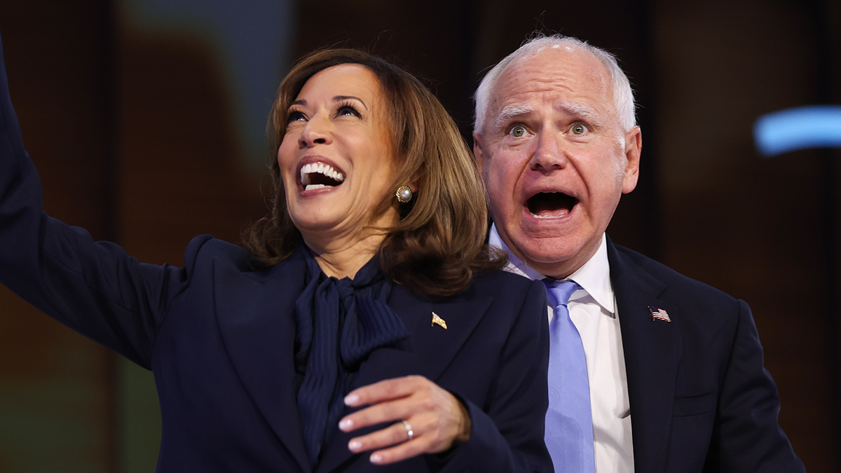 Kamala Harris and Tim Walz celebrating on stage