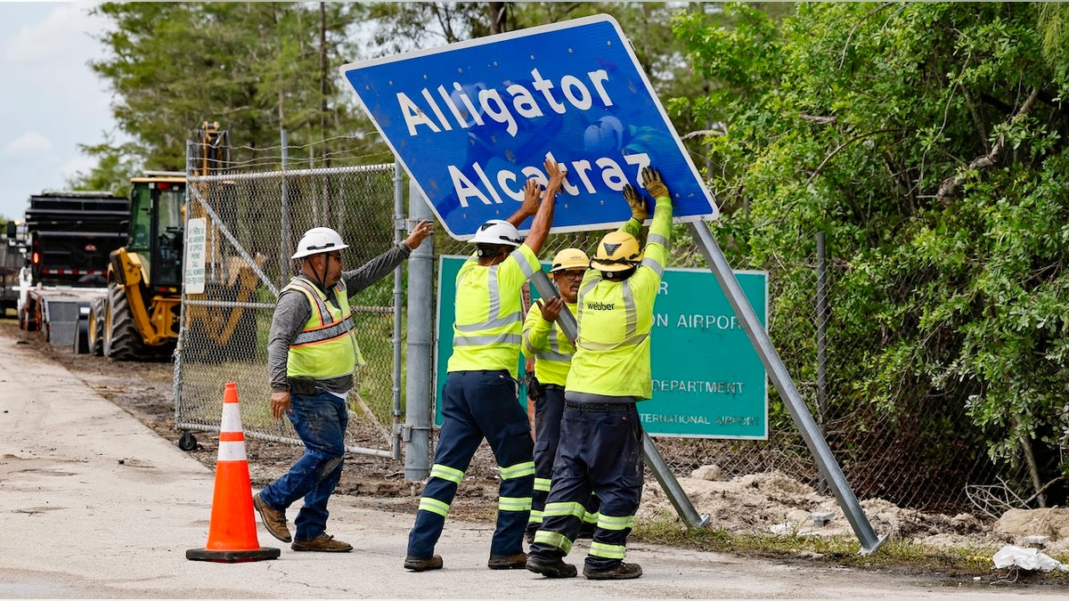 Florida workers install Alligator Alcatraz sign