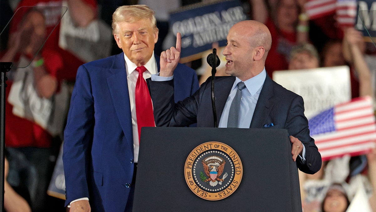 Stephen Miller with Donald Trump at rally