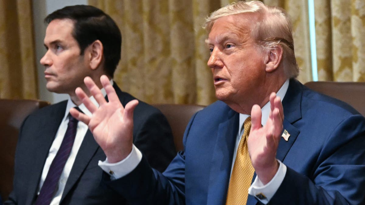 President Donald Trump talks to reporters during a Cabinet meeting. 