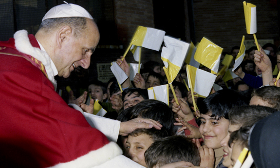 File photo of Pope Paul VI greeting children during Rome parish visit in 1968