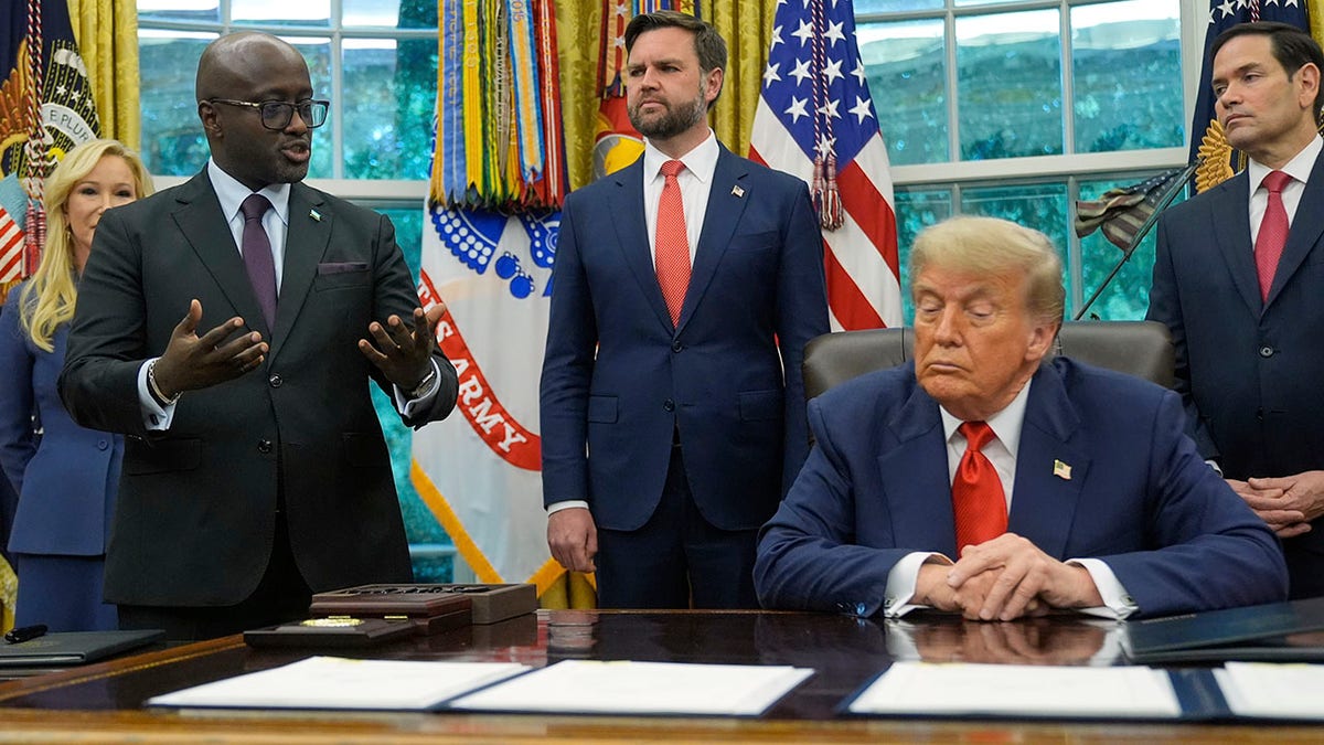 President Donald Trump listens as Rwanda's Foreign Minister Olivier Nduhungirehe