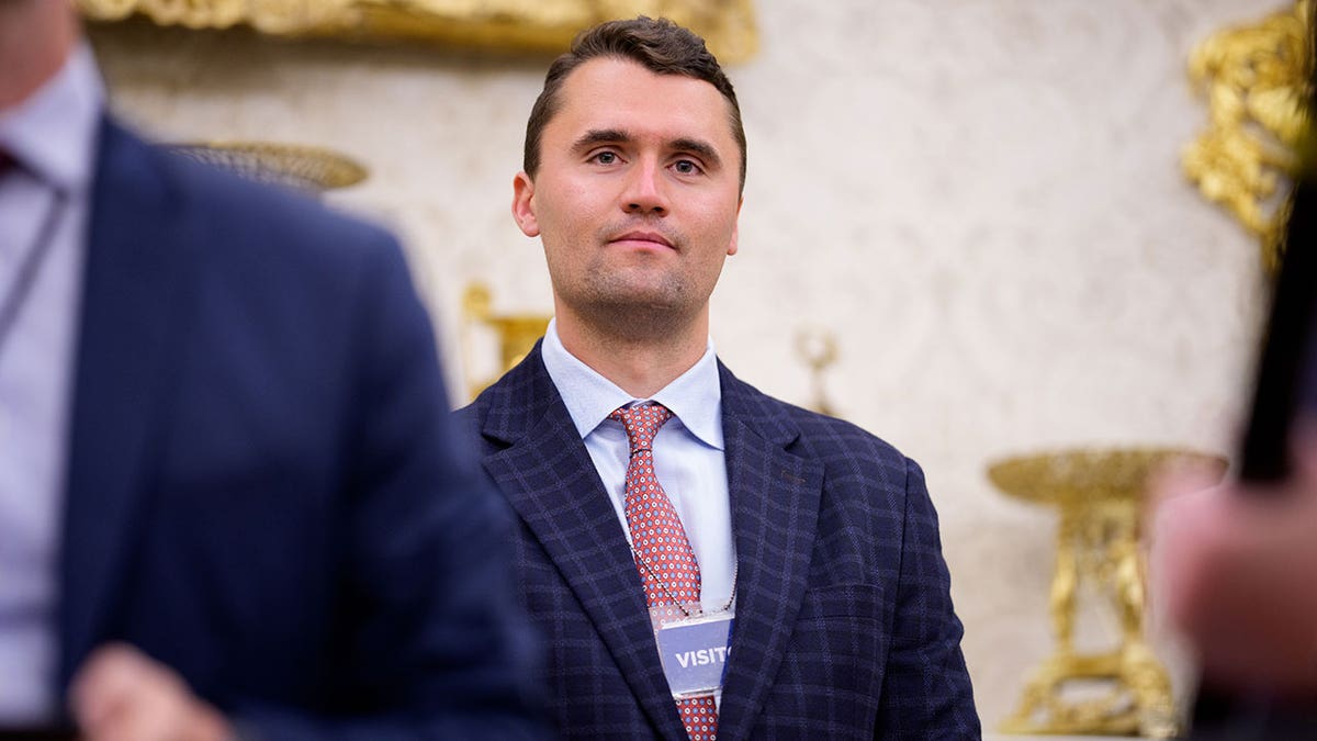 Turning Point USA co-founder Charlie Kirk stands in a room at the White House