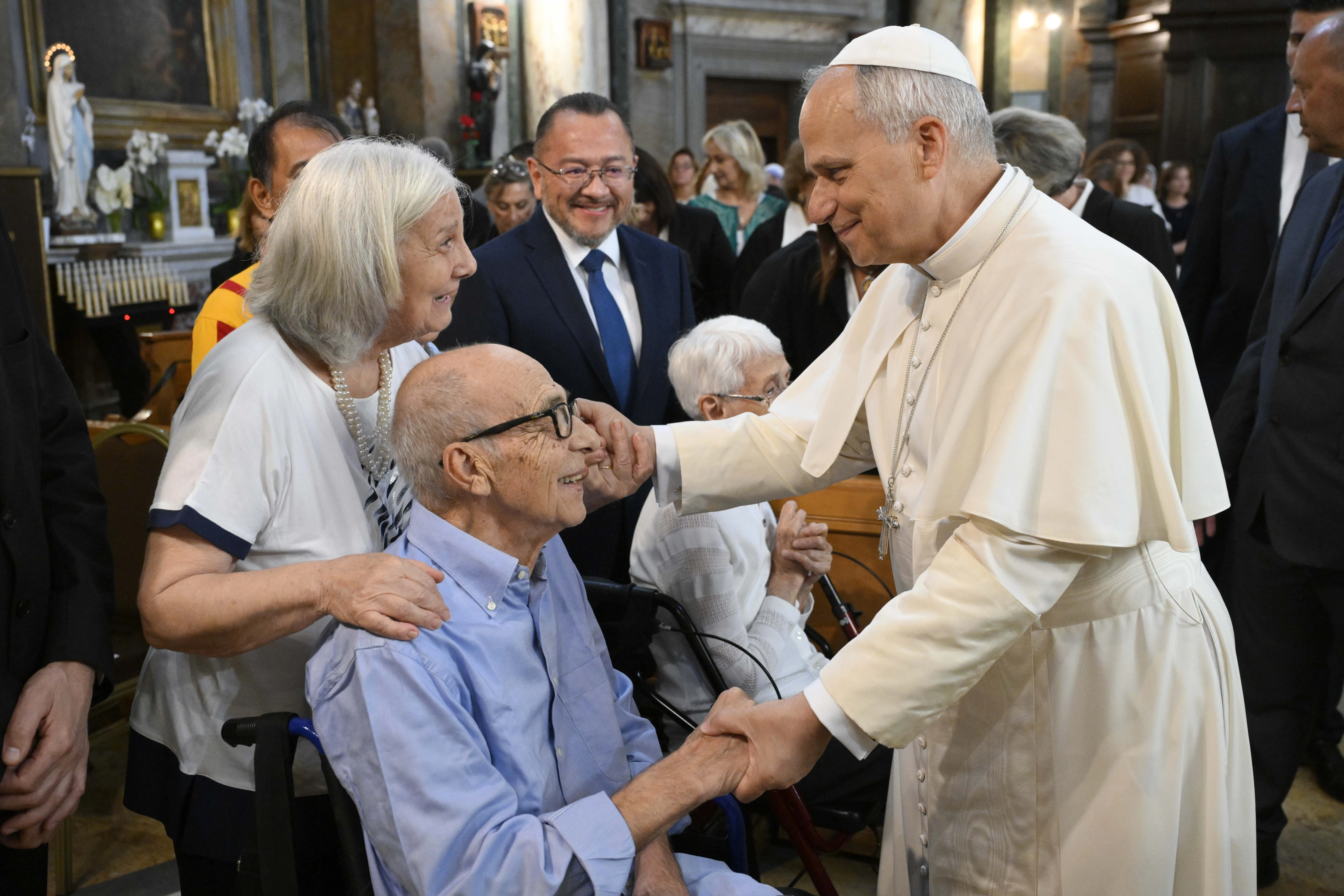 Pope Leo is pictured here speaking with a couple  at the Parish Church of St. Anne in the Vatican on Sept. 21, 2025. Credit: Vatican Media