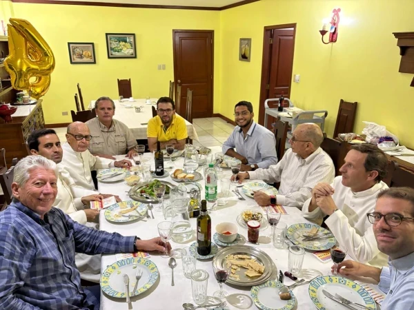 Father José Giner shares a meal with friends. Credit: Father José Giner