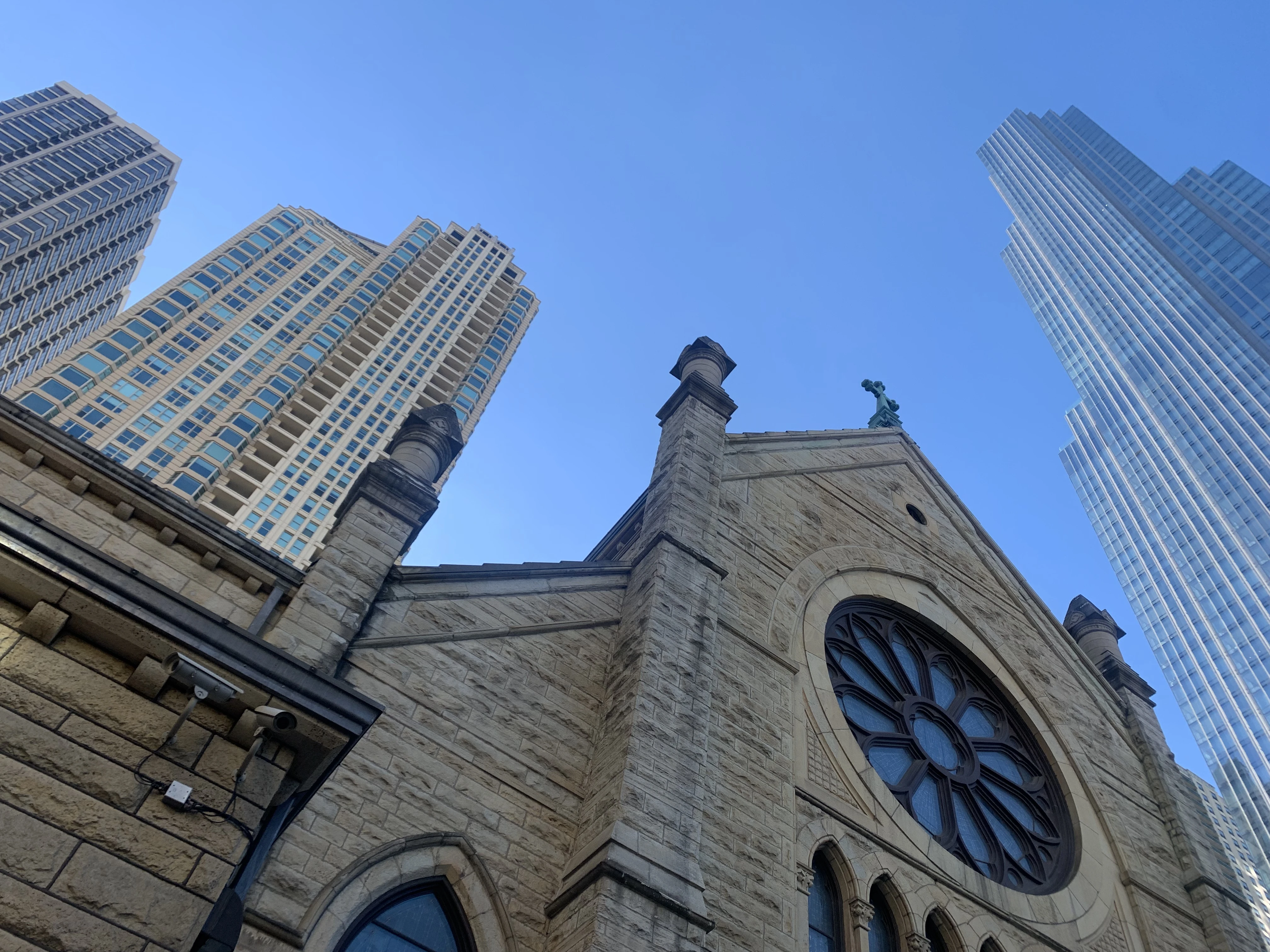 Holy Name Cathedral in Chicago with One Chicago Square in the background, a residential tower constructed on the former cathedral parking lot, which was sold in 2019. Courtesy of Maddy Johnson/Church Properties Initiative