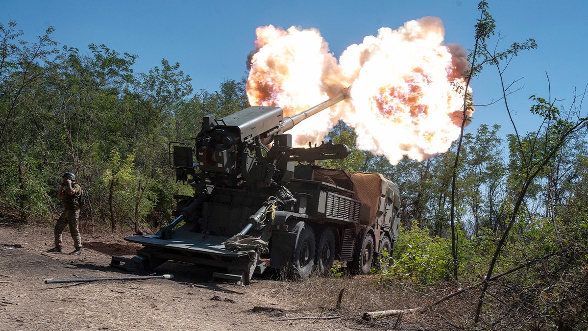 Ukrainian servicemen fire a 2s22 Bohdana self-propelled howitzer toward Russian positions.
