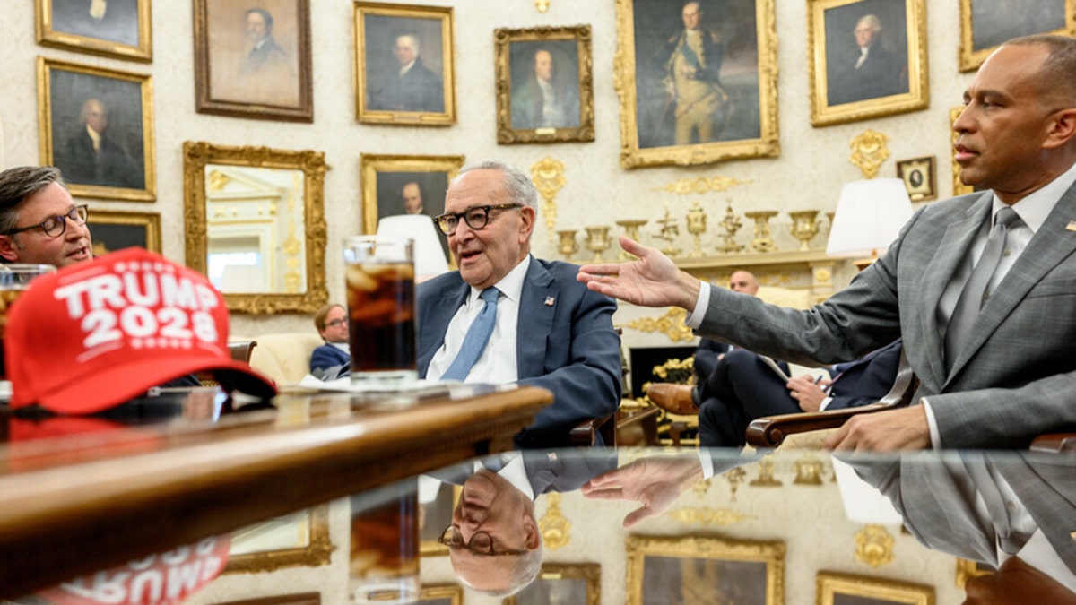Trump 2028 hat in foreground during Oval Office meeting with Schumer