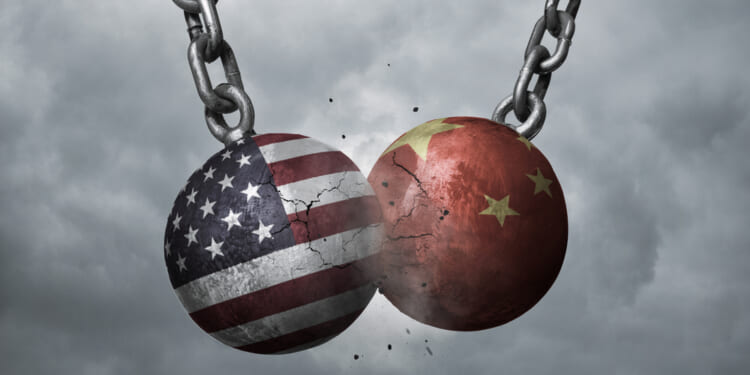 Two wrecking balls with american and chinese flags hitting each other, battery production weaponization concept