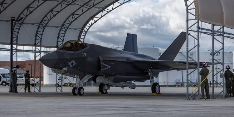 An F-35C fighter in a hangar.