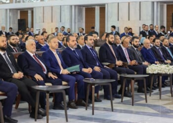 Syrian president Ahmed al-Shara and US Envoy Tom Barrack sit in a meeting.