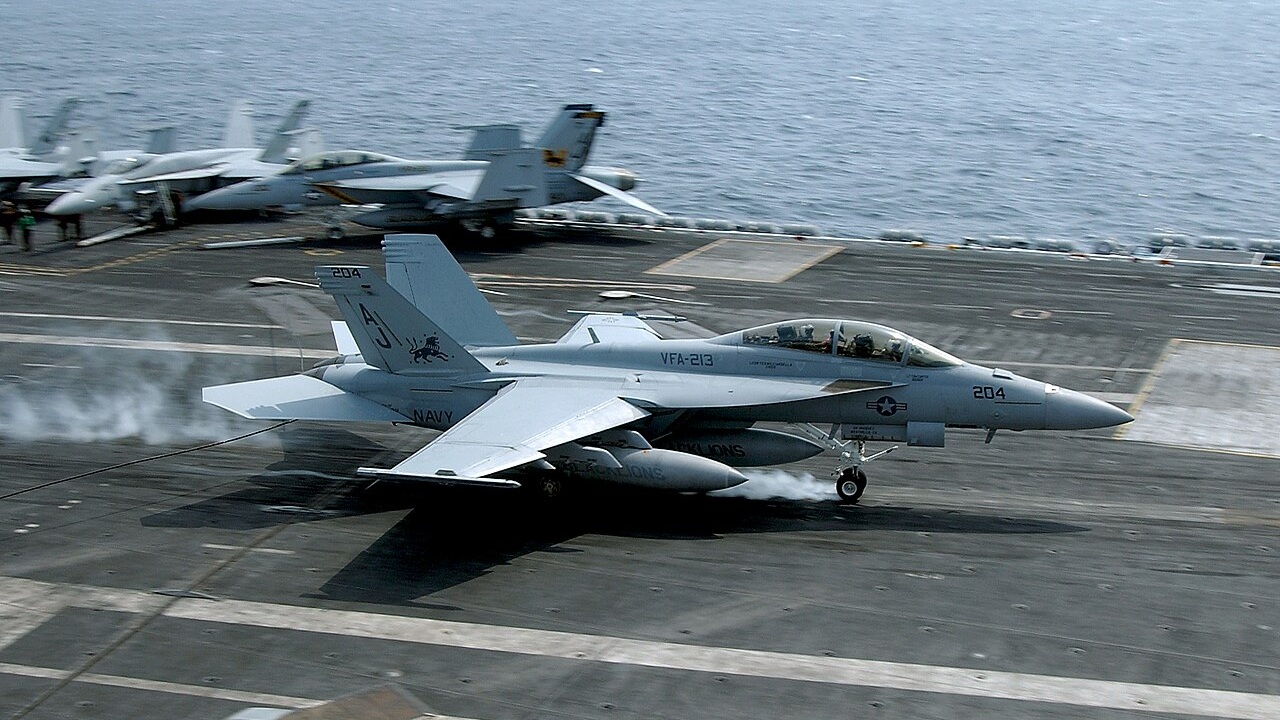 An F/A-18 Super Hornet taking off from an aircraft carrier.