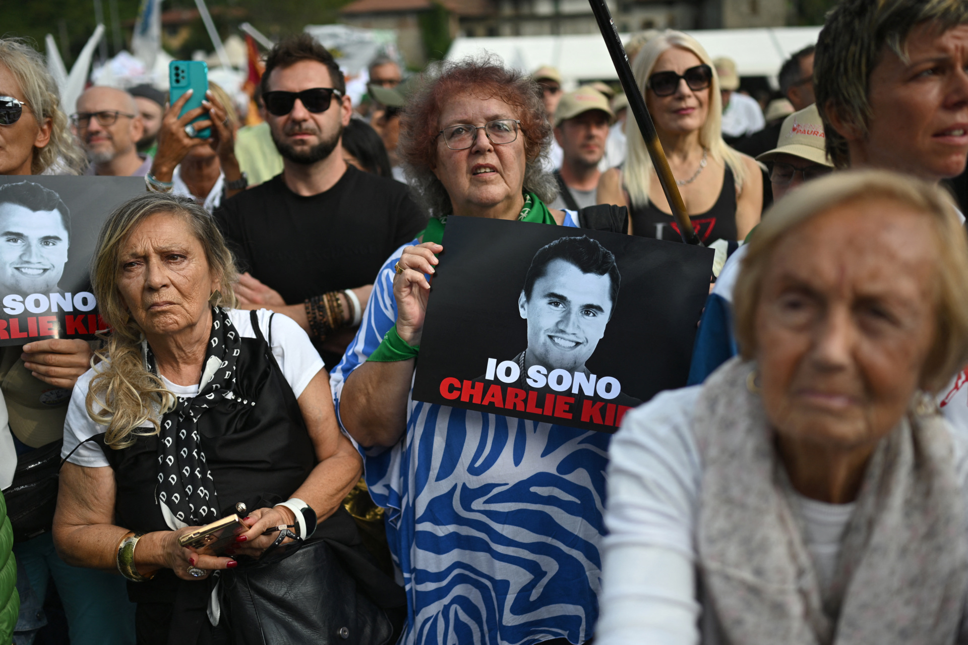 Supporters of the Lega Party hold posters reading "I am Charlie Kirk" during the annual rally of the Italian far-right League (Lega) party in Pontida, northern Italy on September 21, 2025. (Photo by PIERO CRUCIATTI / AFP) (Photo by PIERO CRUCIATTI/AFP via Getty Images)