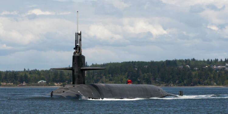 The Gold Crew of the Ohio-class ballistic-missile submarine USS Alabama (SSBN 731) transits the Hood Canal as the boat returns home to Naval Base Kitsap-Bangor following a routine strategic deterrent patrol.