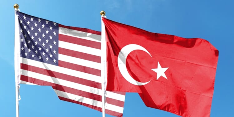 American flag and Turkish flag on cloudy sky. nuclear energy partnership