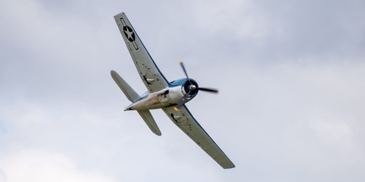 A Grumman F6F Hellcat flying overhead.