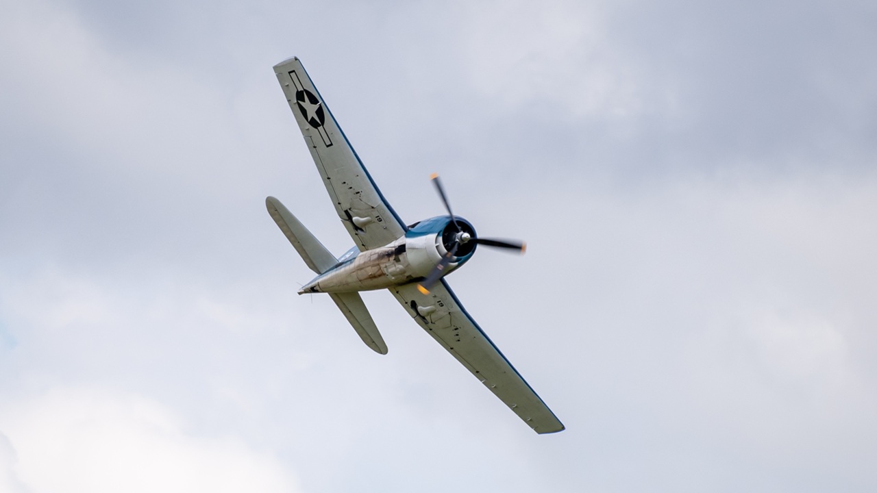 A Grumman F6F Hellcat flying overhead.