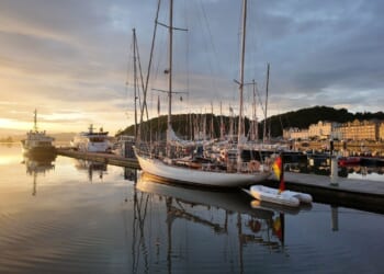 A British sailing ship at dock.