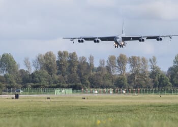 A B-52 landing at an airfield.
