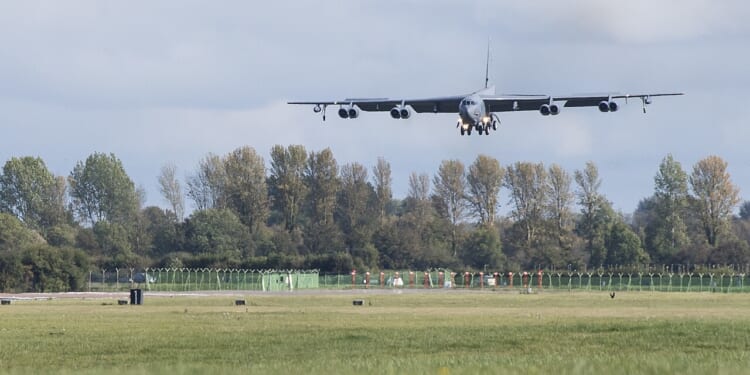 A B-52 landing at an airfield.