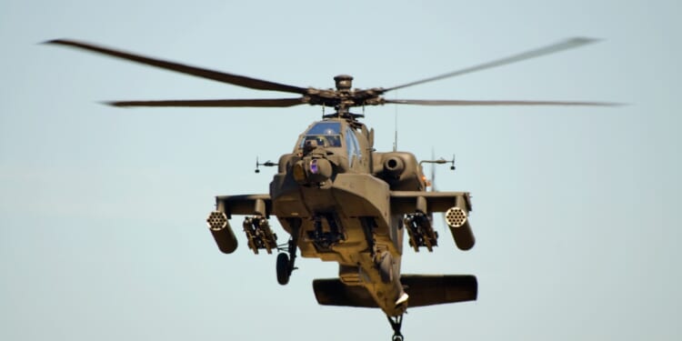 An AH-64 Apache attack helicopter in flight.
