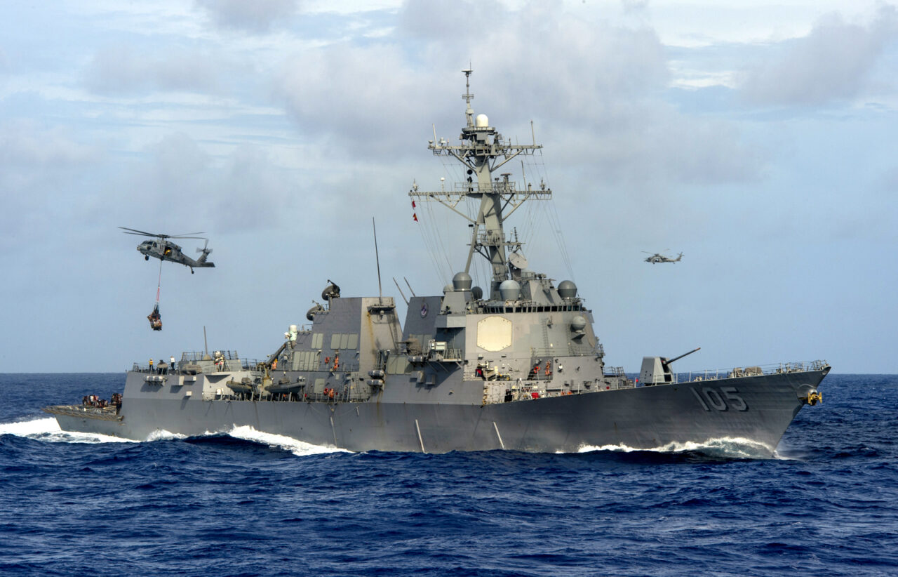 The Arleigh Burke-class guided-missile destroyer USS Dewey (DDG 105) conducts a vertical replenishment.