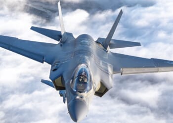 An F-35 over clouds.