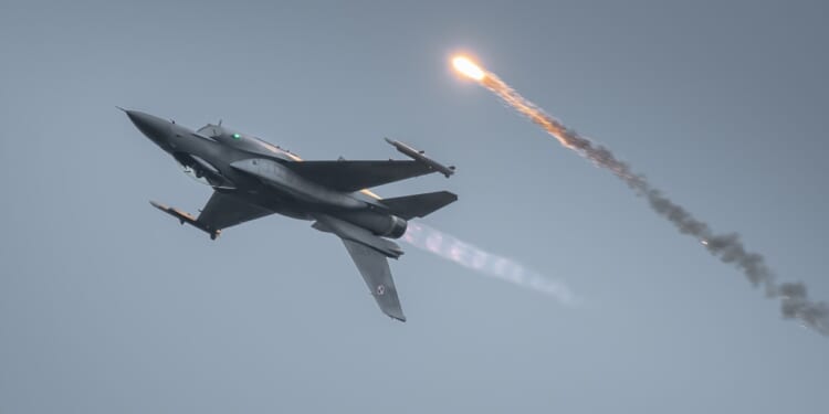 An F-16 flying upside down.