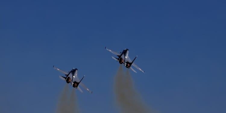 Two Russian fighter jets in flight.