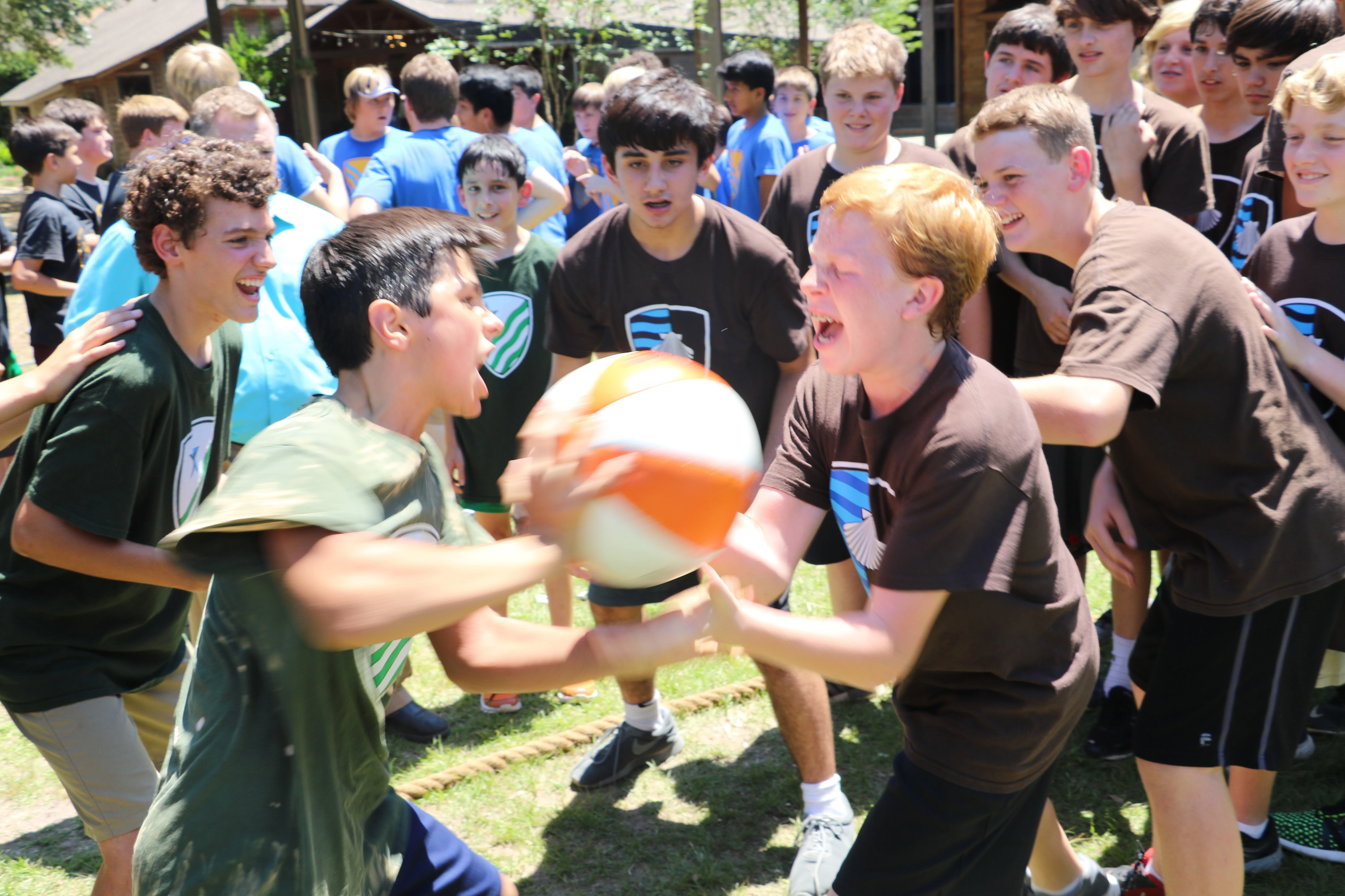 Boys cheer their teammates on as the houses compete in a game of "Thud," in which two boys throw a medicine ball at one another as hard as they can until one of them drops it or gives up. Credit: Courtesy of Western Academy