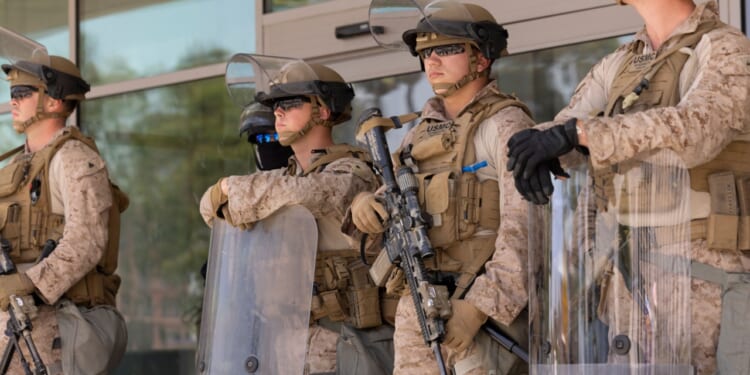 US marines stand guard at protests in LA.