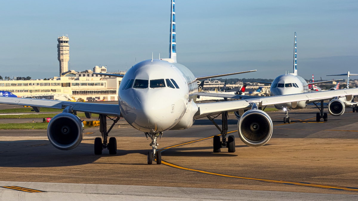 Commercial planes ready to take off on taxiway