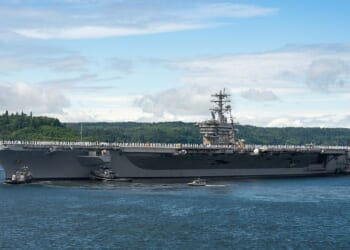 Sailors standing at attention on the USS Nimitz.