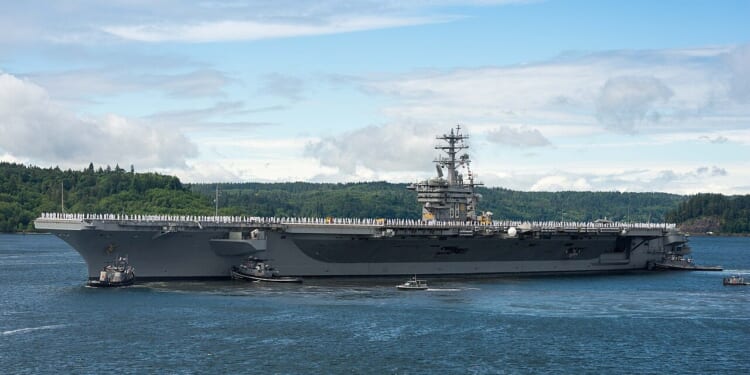 Sailors standing at attention on the USS Nimitz.